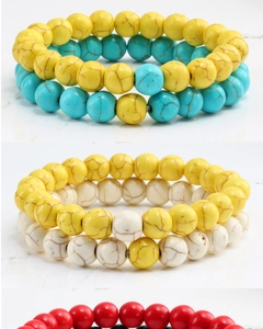 Detailed stack of beaded bracelets featuring colorful turquoise and matte black stone beads