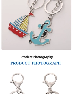 Detailed view of colorful enamel nautical charms featuring a sailboat and an anchor keychain