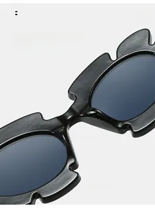 Detail shot of black jelly sunglasses with wave-edge frames and comfortable nose pads