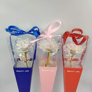 Close-up of artificial gold foil roses in blue, pink, and red gift box packaging