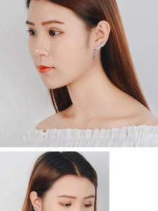 Silver leaf earrings with rhinestone fringe tassels showing close-up jewelry details