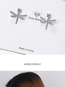 Detailed view of silver dragonfly stud earrings featuring sparkling cubic zirconia stones