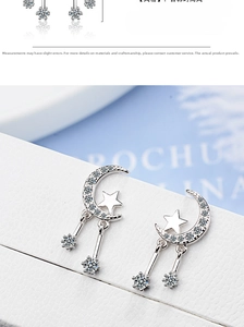 Detail shot of moon and star tassel earrings with sparkling white zircons in silver finish