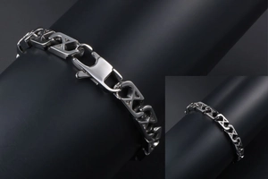Macro shot of polished silver mesh bracelet with X-shaped links and secure lobster clasp