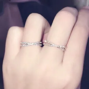 Crossed 18k rose gold and silver rings with shimmering micro-pave crystals for women