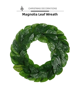 Detailed close-up of artificial magnolia leaf wreath with lush green textures and realistic veins