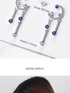 Detailed macro view of moon-shaped earrings with blue zircon tassels and model display