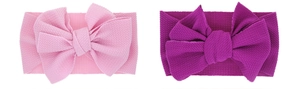 Detail of pink waffle knit elastic baby headbands with oversized rabbit ear bow