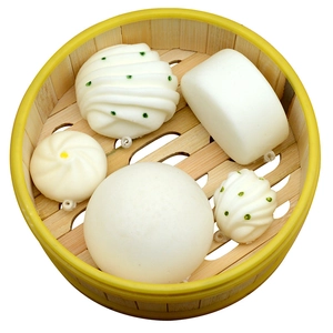 5-piece simulation steamed bun squishy keychain set displayed in a wooden steamer tray