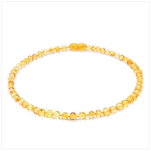 Macro detail of natural Baltic amber baby necklace with hand-knotted honey beads