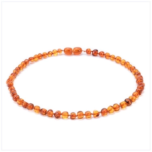 Close-up of natural Baltic amber beads showing warm orange tones and organic textures