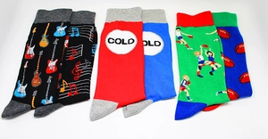 Detailed flat lay of three crew socks with musical instruments and sports patterns