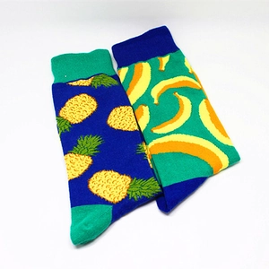 Close-up of cotton crew socks featuring vibrant pineapple and banana fruit patterns