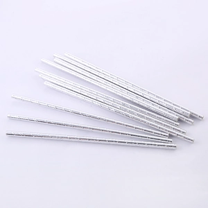 Detail view of twelve silver spiral patterned paper straws for party use on white background