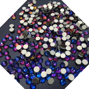 Macro shot of iridescent flatback rhinestones for nail art in blue and pink tones