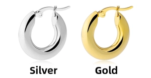 Close-up of thick stainless steel hoop earrings in polished silver and gold finishes