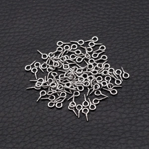 Macro view of silver stainless steel eye pins for DIY jewelry making and craft projects