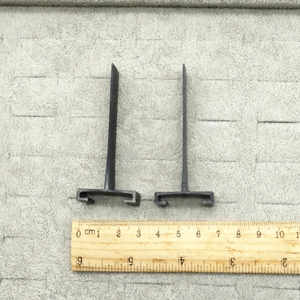 Close-up of black 2.5cm headband slide connectors with ruler for size reference