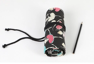 Macro shot of rolled black canvas pencil wrap with elegant ballerina print design