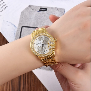 Close-up of Geneva women watch featuring crystal butterfly dial and gold metal strap
