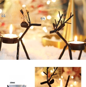Detail of black reindeer tea light candle holders on a snowy winter background