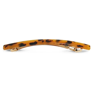 Detail of tortoiseshell acetate hair clip with golden metal spring clasp mechanism