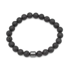 Close-up of black volcanic stone beads with metallic cylinder charm on white background