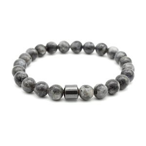 Detailed view of elastic beaded bracelet with grey spotted stones and hematite bead