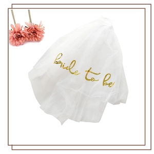 White tulle bridal veil with gold glitter Bride To Be script and built-in comb