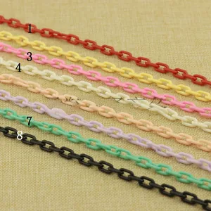 Close-up of colorful resin link chains for DIY jewelry making in eight vibrant shades