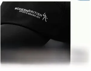 Detailed close-up of white silk-screened lettering and embroidered logo on a black sports cap
