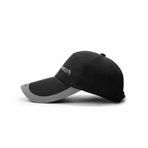 Detail of a black sports baseball cap featuring a reflective grey brim for night safety