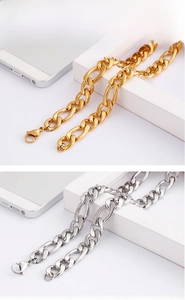 Detailed view of polished stainless steel gold and silver Figaro chains with lobster clasp