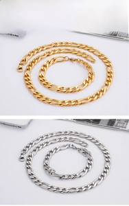 Close-up of polished gold and silver Figaro chain necklace and bracelet jewelry set
