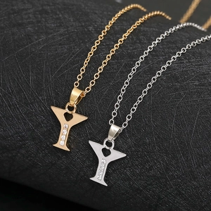 Macro detail of Y-shaped pendants in gold and silver with rhinestones and heart design