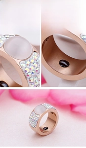 Macro detail of rose gold ring with opal, colorful diamonds and inlaid magnetic stone