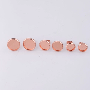 Row of rose gold stainless steel earring studs in various sizes for jewelry making