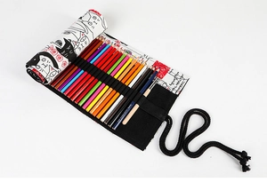 Detail of canvas roll-up pencil case with cartoon cat patterns and colored pencils