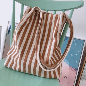 Close-up of brown and white striped canvas tote bag showing durable fabric texture