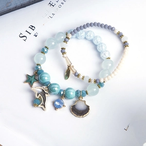 Bohemian ocean theme beaded bracelet set with dolphin and seashell metal charms
