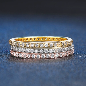 Three-piece stackable wedding ring set in gold, silver, and rose gold with micro-pave zircons
