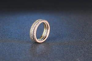 Detail of three-tone eternity rings set in gold silver and rose gold with pavé zircon