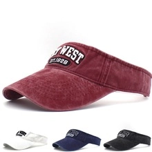 Detail of burgundy distressed cotton visor hat with WEST EST.1928 embroidery detail