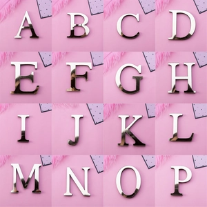 Macro display of silver mirror acrylic letters A to P with reflective 3D surface finish
