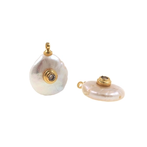 Detailed view of baroque pearl button pendants with gold edging and micro-inlaid zircon