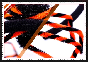 Close-up of Halloween spider accessory with black and orange faux fur spiral texture