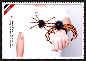 Black and orange plush spider bracelet worn by a model for Halloween party decor