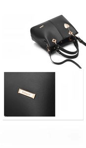 Macro detail of golden hardware logo and lychee pattern leather on black tote bag