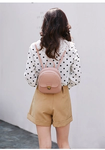 Pink PU leather mini backpack with gold metal lock closure shown on model