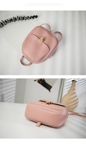 Close-up of pink PU leather backpack with a gold metal lock and elegant shadow lighting